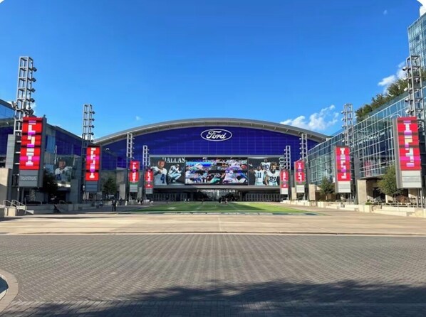 A stadium with a large digital screen, a prominent Ford logo, and multiple advertisements. - Luxury Private En-Suite, Brand New Home. Frisco WiFi,AC and all you need (Frisco)