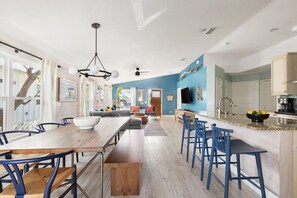 Prepare meals in the spacious kitchen with a large island and dining table for family meals or entertaining.