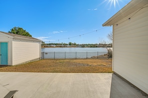 A residential area with a house, a garage, and a fenced yard.