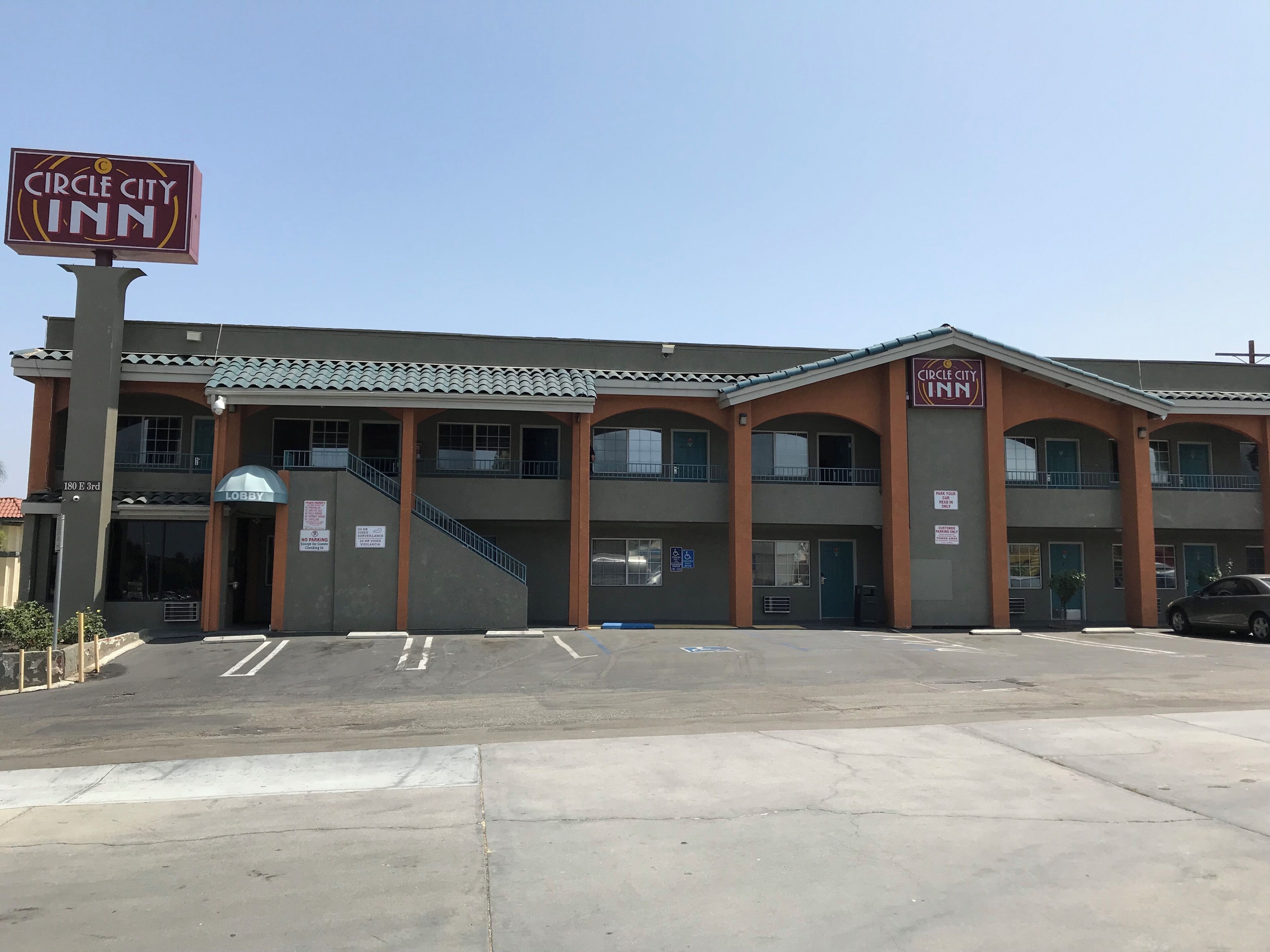 A Circle City Inn building with a two-story structure, a lobby entrance, and a parking lot.
