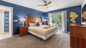 A bedroom with a bed, nightstands, a ceiling fan, and a view of the outdoors. - 3-br Condo Near Disney Family-friendly Retreat (Kissimmee)