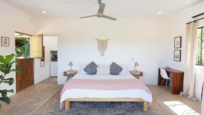 A bedroom with a bed, a desk, a chair, a ceiling fan, and a large window. - Huge Suite!! King Bed, A/C, Saltwater Pool, Fast Wifi, Mountain Views -"Sol" (San Francisco)