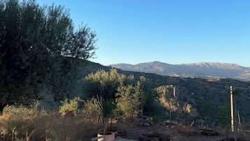 Relax in a serene mountain setting with a clear view of the surrounding landscape from this outdoor seating area.
