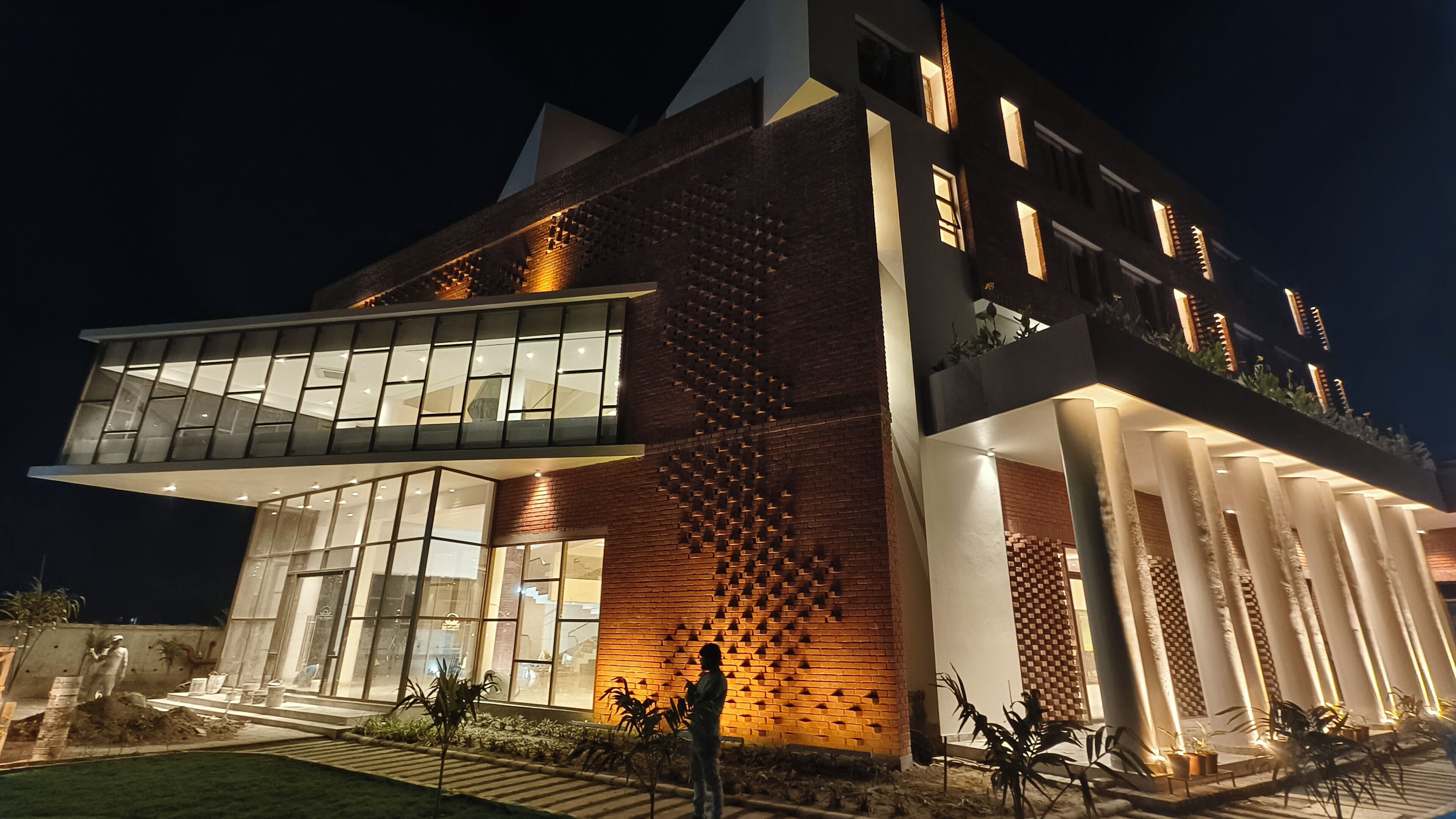 A modern building with large windows and a brick facade.