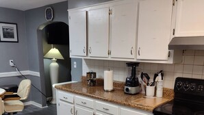A kitchen with white cabinets, a granite countertop, a stove, and a microwave. - Cozy 5-bdrm hm, Loaded Kitchen, w/ Patio 
Deck & Grill, WiFi in pleasant Norfolk (Norfolk)