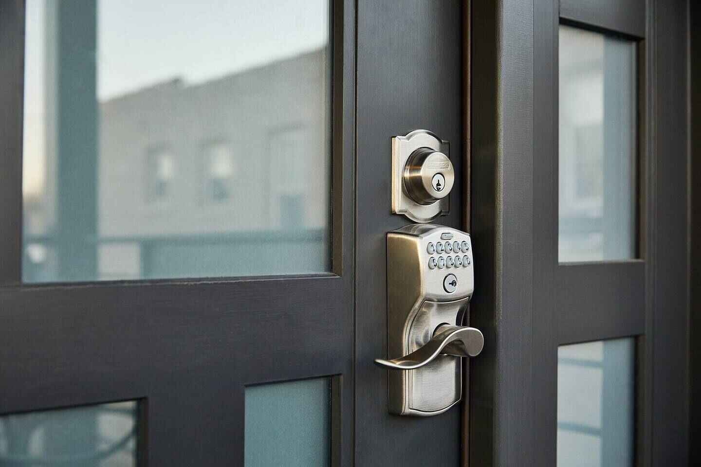 A door with a keypad lock and a keyhole.