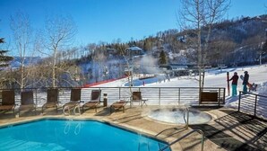A pool area with lounge chairs and a hot tub. - Snowmass_village_3bd_gen_c (Snowmass Village)