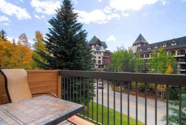 A balcony with a view of a road and buildings.