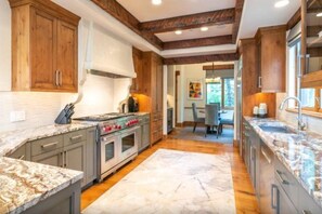 Enjoy cooking in this well-equipped kitchen with a central island, gas stove, and oven, perfect for preparing meals.
