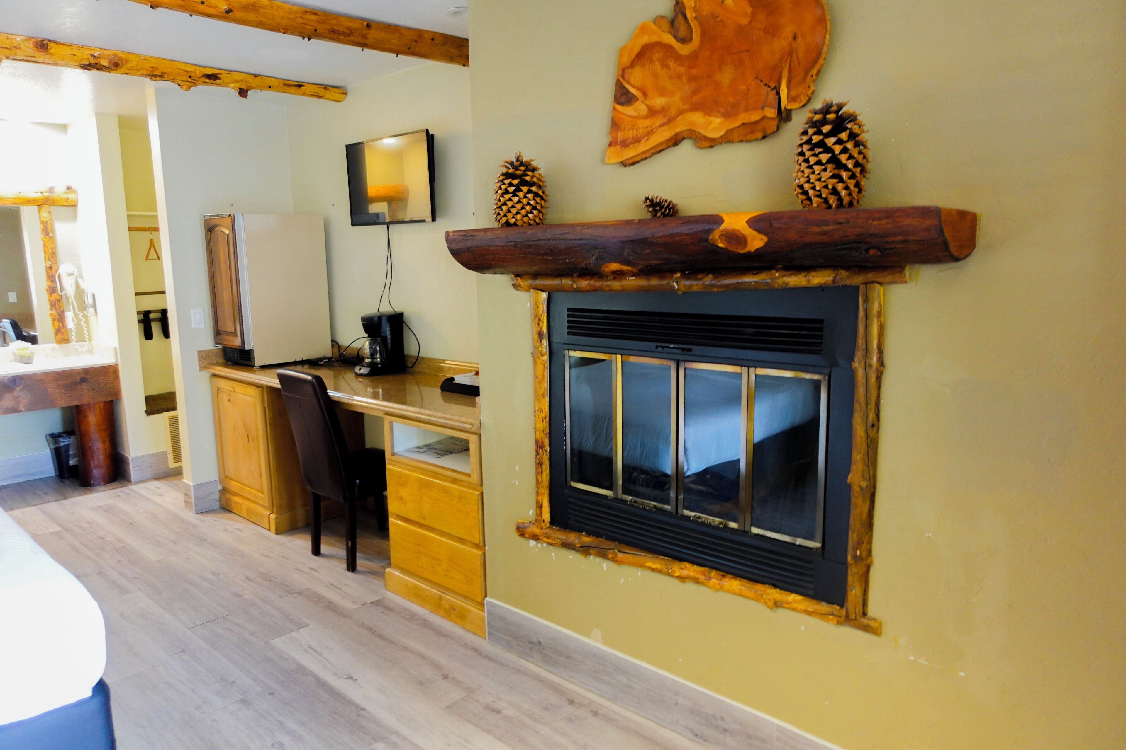 A kitchen with a wooden countertop, a built-in stove, and a window with a decorative frame.