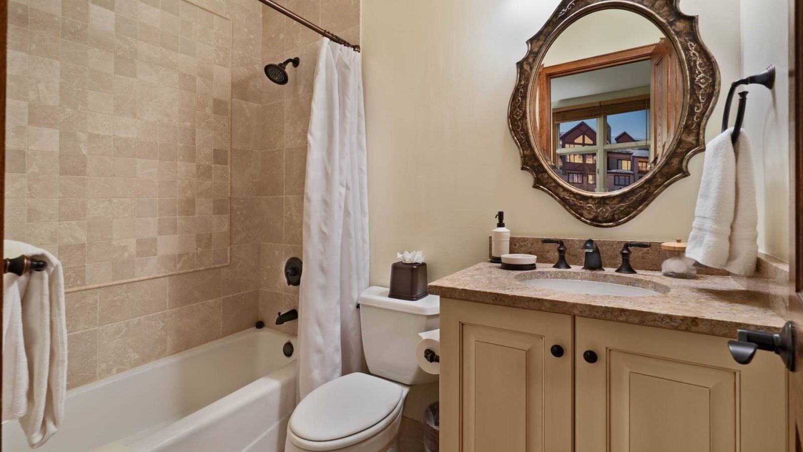A bathroom with a bathtub, toilet, and sink.
