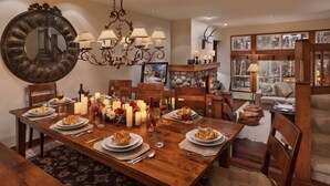 A dining room with a wooden table set for a meal, surrounded by chairs. - Beaver_creek_chalet_verve (Avon)