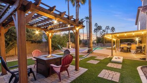 A patio area with a pergola, outdoor furniture, and a pool. - Paradise Palms House with Resort-Style Backyard, Pool and Hot Tub (Scottsdale)