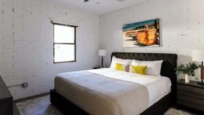 A bedroom with a bed, a ceiling fan, a window, and a painting on the wall. - Nova-400k Backyard! Old Town and Ent District! (Scottsdale)