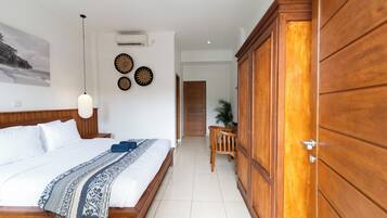 A bedroom with a wooden bed, a nightstand, a wall-mounted air conditioner, and a ceiling light.