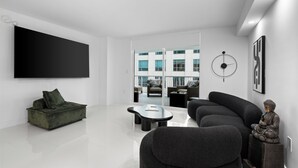 A modern living room with a sofa, a coffee table, and a Buddha statue. - Luxury apartment in downtown Brickell with SEA view, Miami  (Miami)