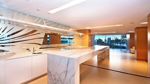 A modern kitchen with a marble countertop, a glass backsplash, and a view of the cityscape. - Oracle Resort 2 Bedroom Premium City Hosted by Gold Coast Luxury Resorts (Broadbeach)