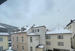 A hotel with a snow-covered roof, a visible sign reading 'HOTEL RHEINLUST,' and a mountainous backdrop. - Hotel Rheinlust (Boppard)