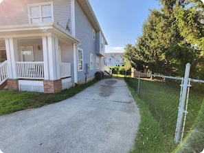 Stroll up to this charming home, featuring a front porch and a welcoming entrance.