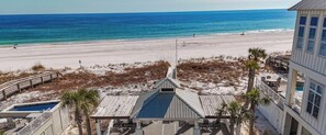 A beach house with a pool, a covered deck, and a view of the ocean. - Coastal Cottage by Kaiser Vacation Rentals Cottages at Romar C4 (Orange Beach)