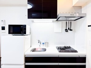 Fridge, microwave, coffee/tea maker, cookware/dishes/utensils
