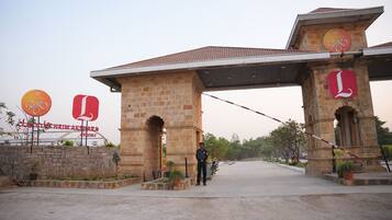 A stone entrance with two large arches and a gate.