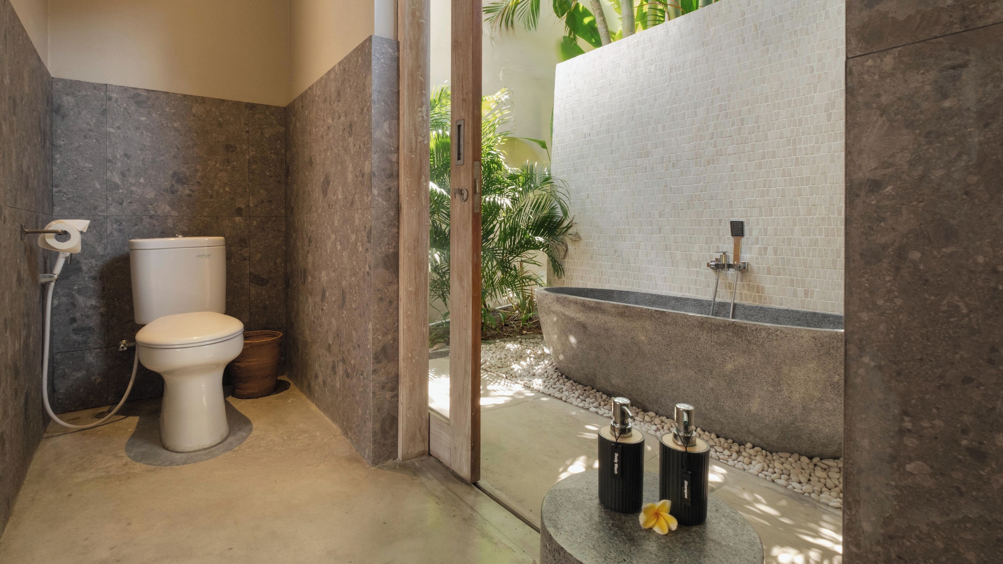 Un baño moderno con inodoro, bidé y una bañera grande.