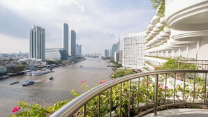 A river with boats, high-rise buildings, and a white building with balconies.