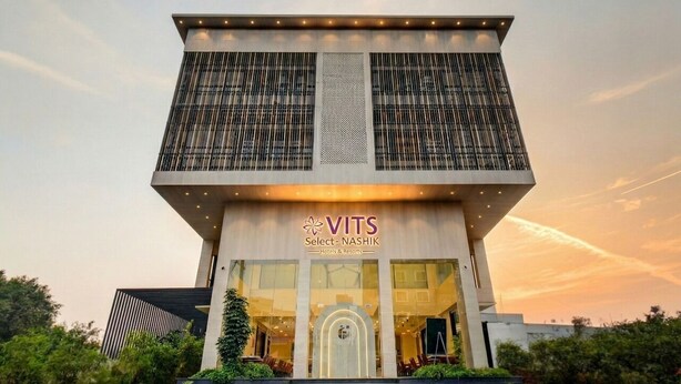 A modern hotel building with a prominent entrance, large windows, and a sign reading "VITS Select - NASHIK Hotels & Resorts". - VITS Select Nashik (Nashik)