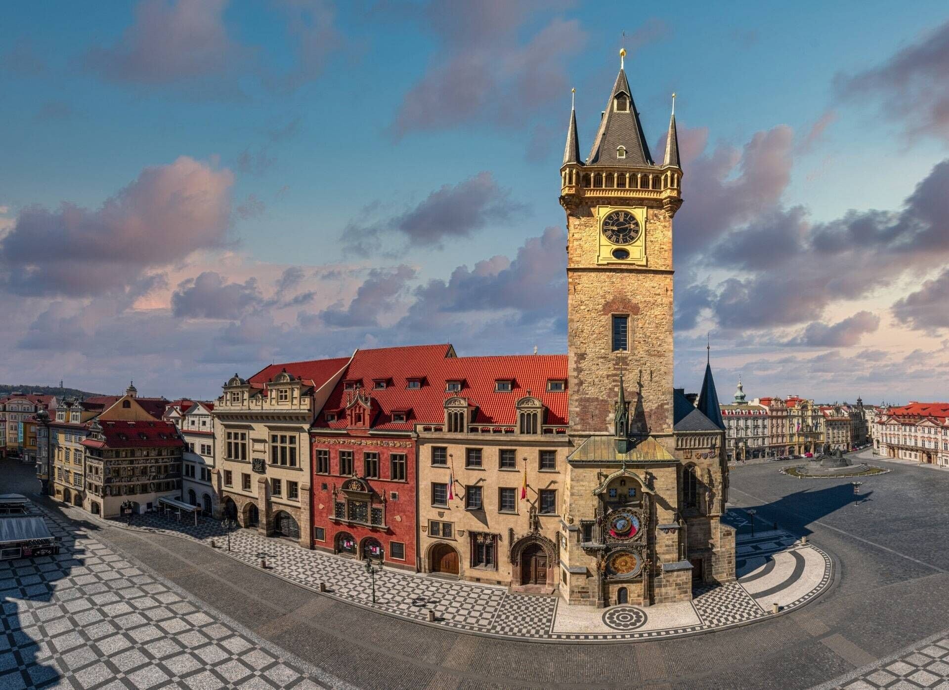 A historic square with a prominent clock tower, cobblestone streets, and traditional architecture.