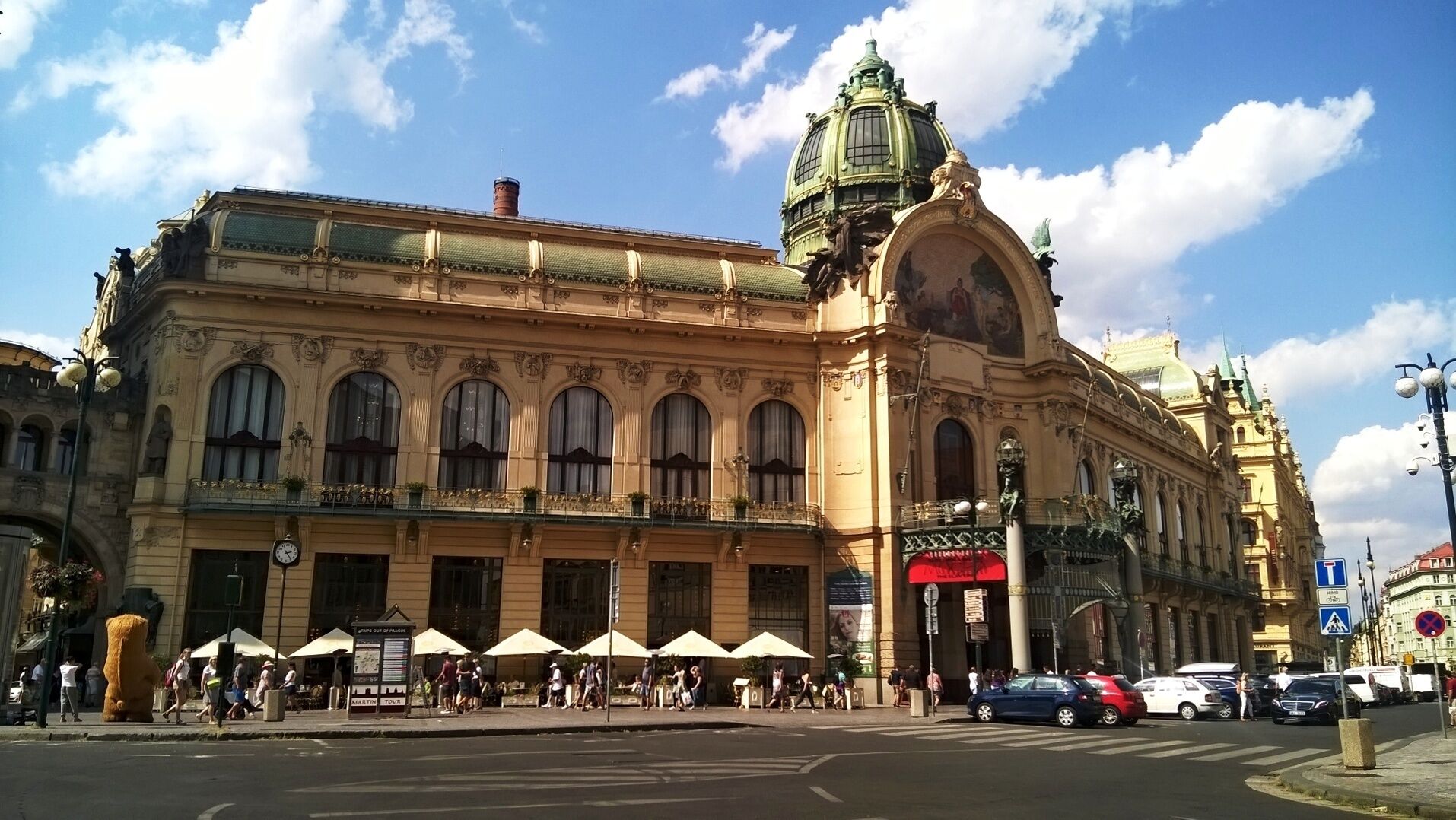 A historic building with ornate architecture, large windows, and a prominent dome.