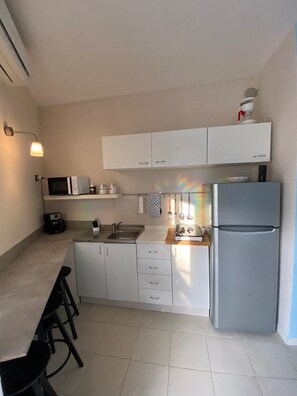 Enjoy meals at the compact dining table with four chairs.
