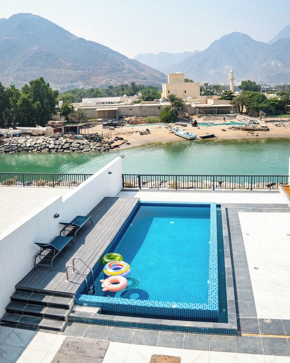 Relax by the rectangular pool surrounded by lounge chairs and take in the breathtaking views of the surrounding mountains.