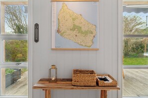 A map on a wall, a thermometer, and a table with baskets and a lantern. - Renovated family home in Listed - Close to sea (Svaneke)