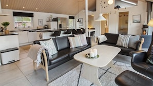 A modern living room with a sofa, coffee table, and a fireplace.