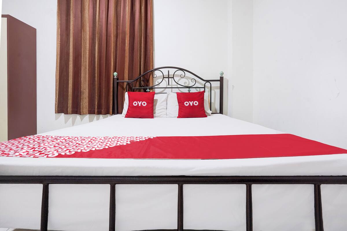Laptop workspace, bed sheets