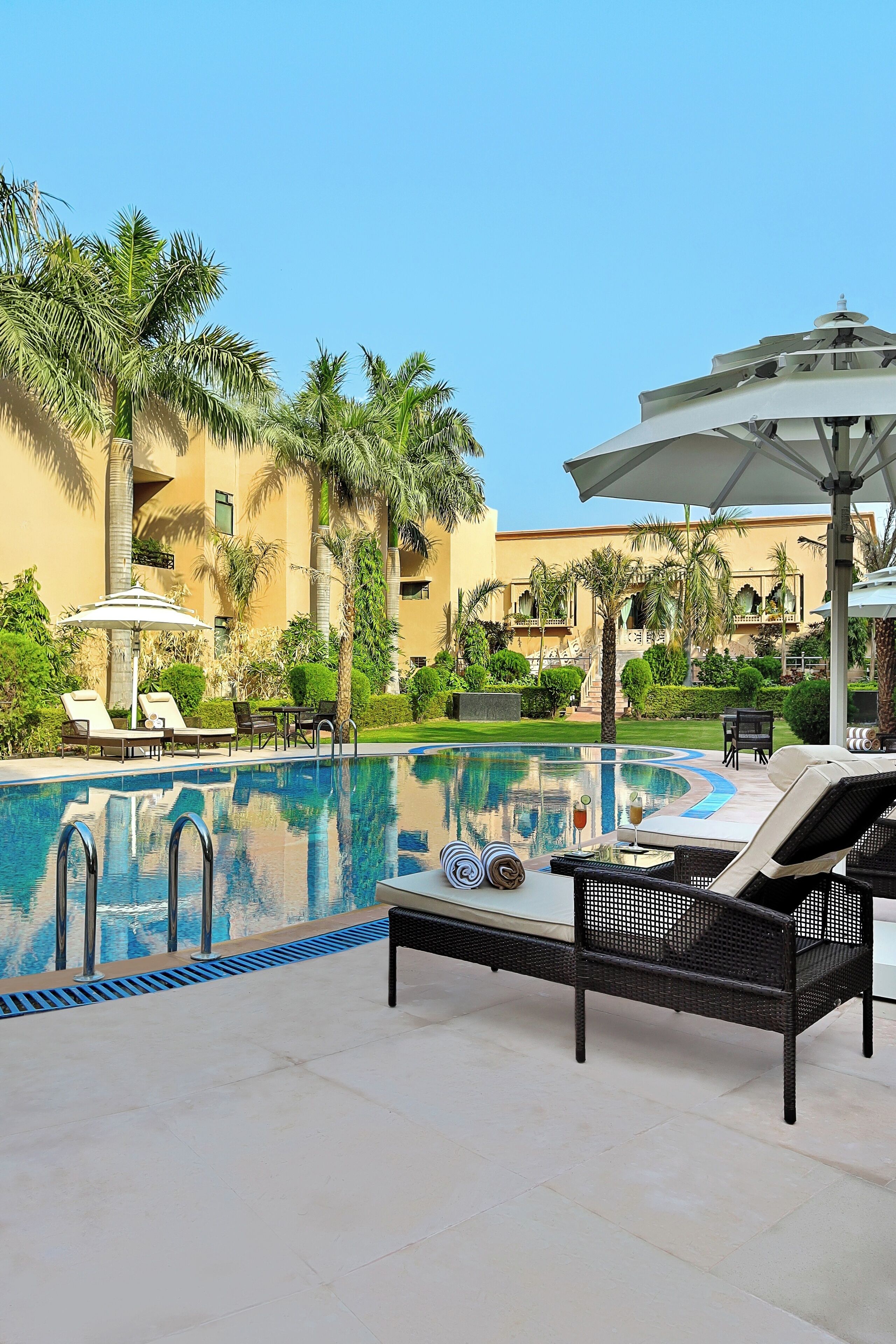 Outdoor pool, open 7:00 AM to 7:00 PM, pool umbrellas