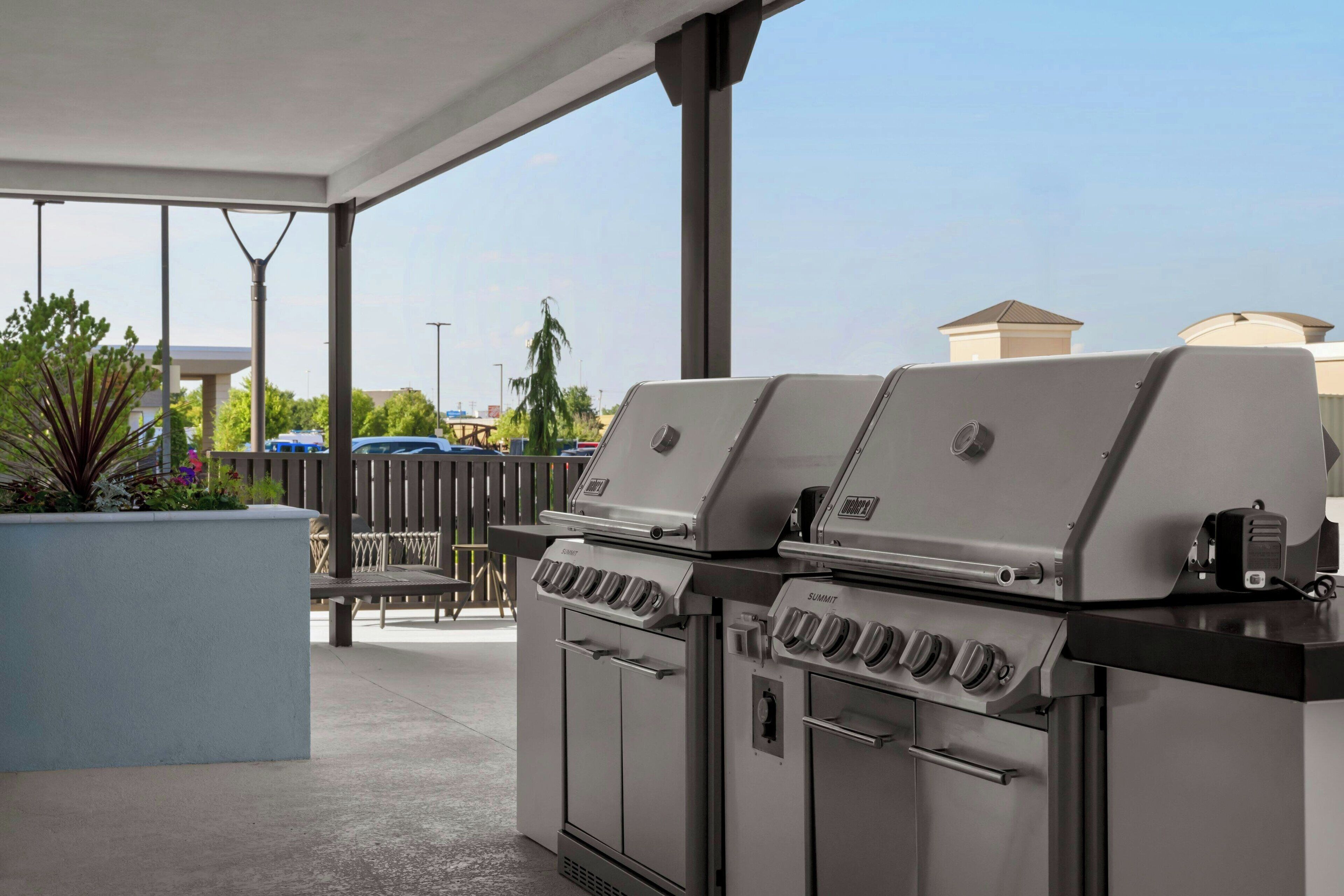A covered outdoor area with two Summit gas grills.