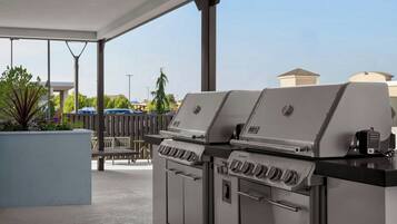 A covered outdoor area with two Summit gas grills.