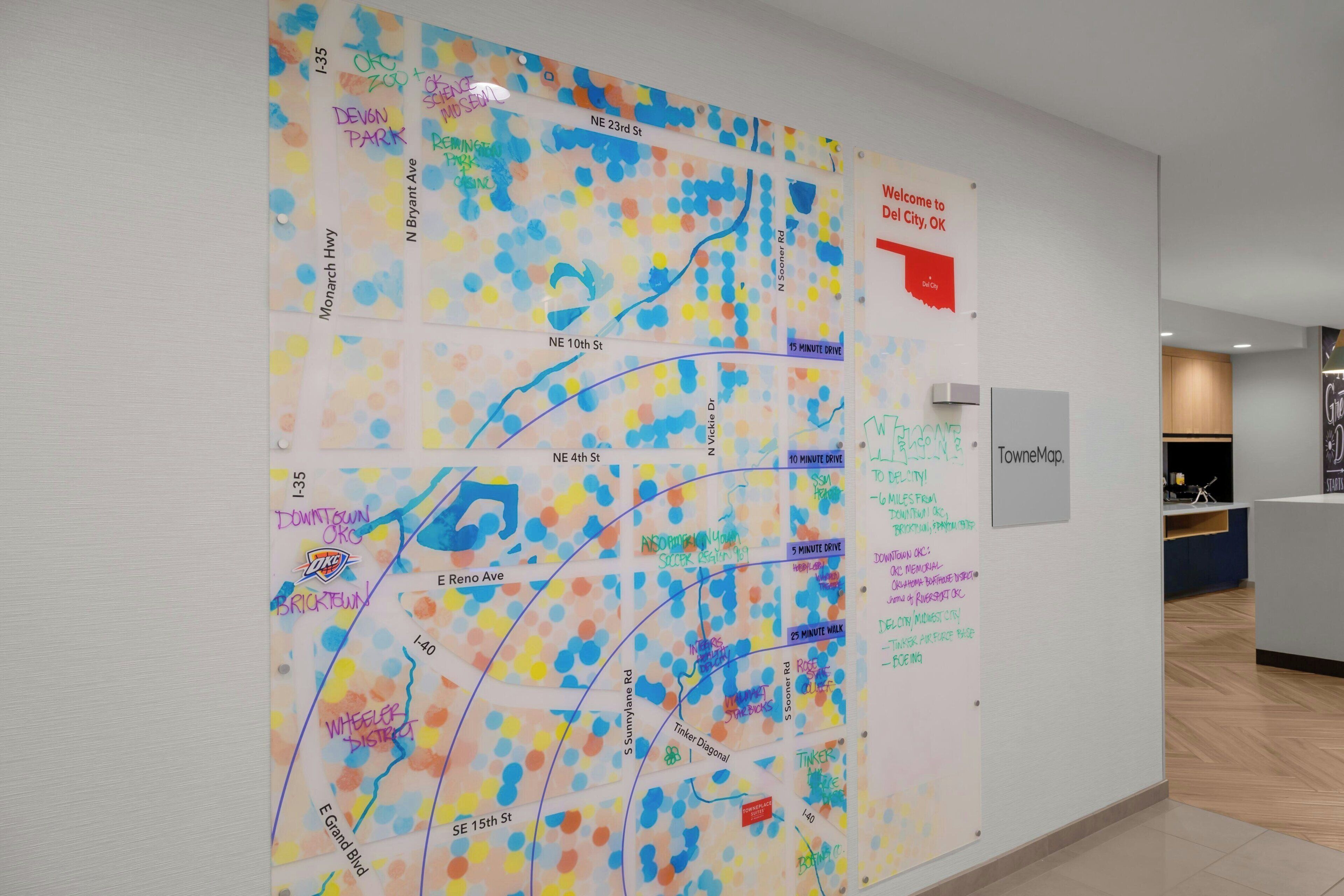 A wall with a colorful map and a welcome sign.