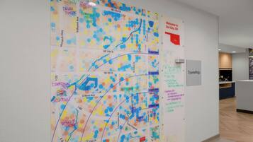 A wall with a colorful map and a welcome sign.