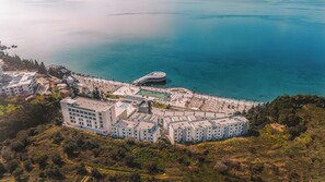 An aerial view of a coastal hotel with multiple buildings, a swimming pool, and a beach area. - Hotel Vlora Priam, Affiliated By Meliá (Vlorë)