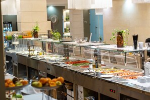 A buffet setup with various food items and condiments. - Hotel Vlora Priam, Affiliated By Meliá (Vlorë)