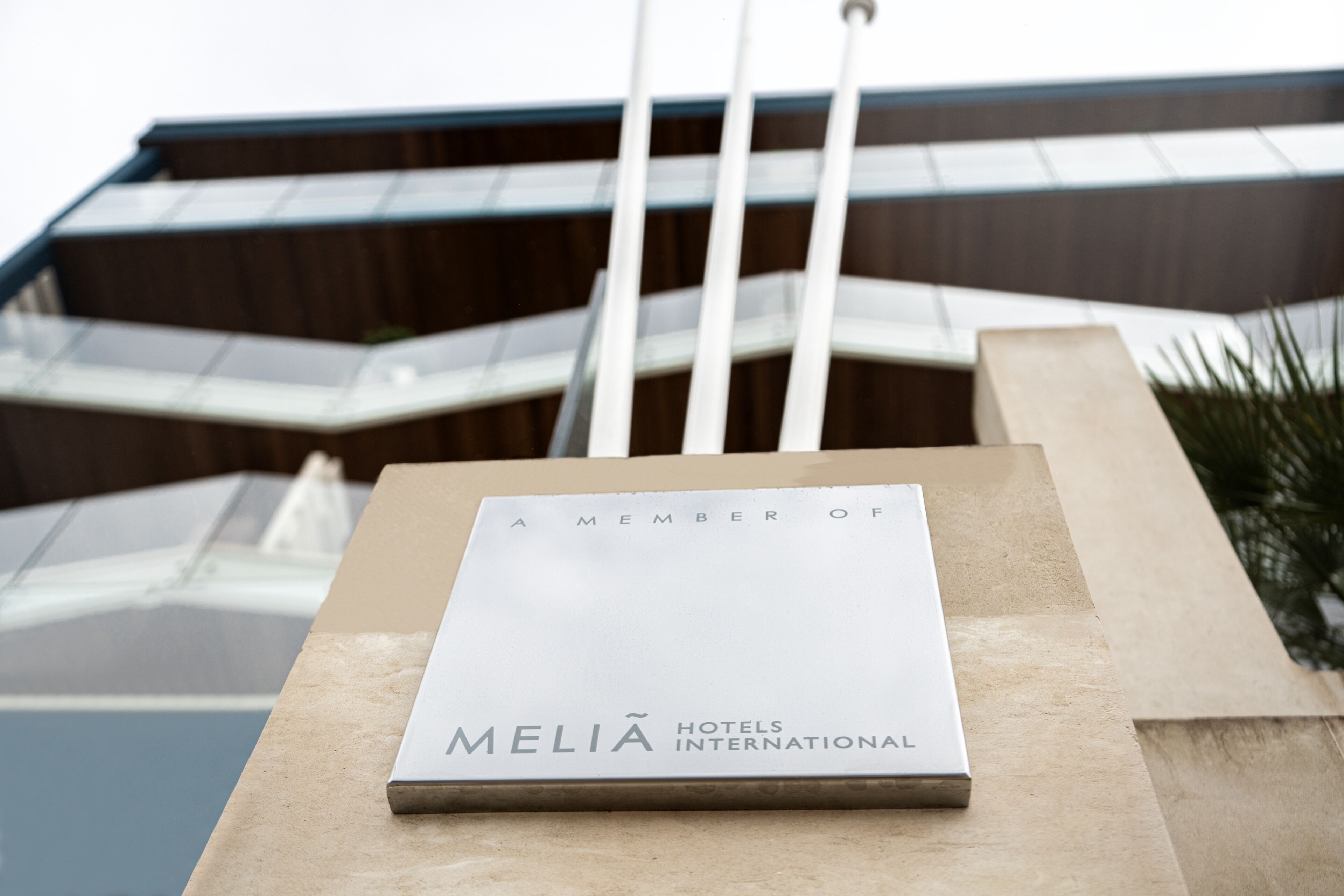 Eine Gedenktafel an einem Gebäude mit dem Text 'A MEMBER OF MELIA HOTELS INTERNATIONAL'.