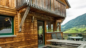 A wooden cabin with a balcony, a deck, and a view of the surrounding landscape. - Chalet  # 72 with 4 BR and infrared sauna (Annaberg)