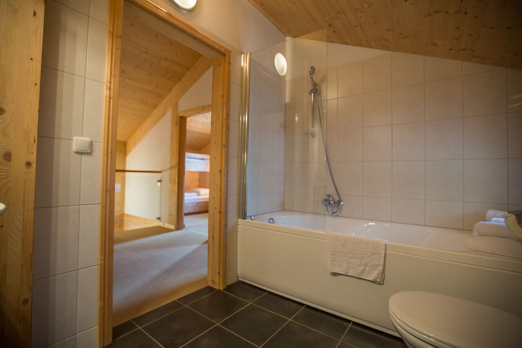 A bathroom with a bathtub, toilet, and shower.