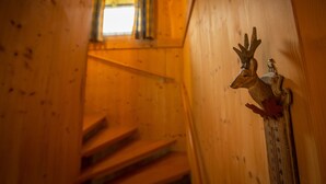 A wooden staircase with a decorative deer head on the wall. - Chalet # 75 with 3 BR for up to 6 people (Annaberg)