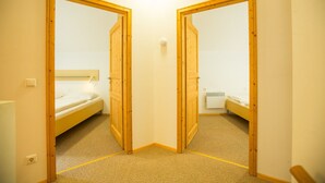 A room with a bunk bed, a bedside table, and a small window. - Chalet # 21 with 3 BR for up to 6 people (Annaberg)