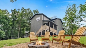 A two-story house with a deck, surrounded by trees. - Trailside Home | Back 40 + OZ Trails Access (Bella Vista)