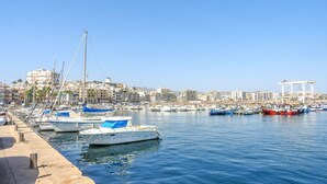 A marina with boats docked, a clear sky, and buildings in the background. - Casa Lodelia: sea and mountain views, nature and beaches just a stone's throw away (San Juan de los Terreros)